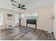 Bright bedroom with ceiling fan, hardwood floors, and access to a private balcony at 533 Grand Vista Trl, Leesburg, FL 34748