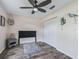 Simple bedroom with ceiling fan, hardwood floors, and double door closet at 533 Grand Vista Trl, Leesburg, FL 34748