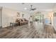 Bright living room with wood-look floors and a view to the kitchen at 533 Grand Vista Trl, Leesburg, FL 34748
