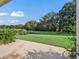 Spacious backyard with lush lawn and pond view at 533 Grand Vista Trl, Leesburg, FL 34748
