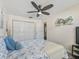 Serene bedroom with ceiling fan, hardwood floors, and large closet at 533 Grand Vista Trl, Leesburg, FL 34748