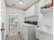 Laundry room with washer, dryer, sink, and cabinets at 533 Grand Vista Trl, Leesburg, FL 34748
