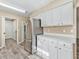 Kitchen with stainless steel refrigerator and white cabinetry at 533 Grand Vista Trl, Leesburg, FL 34748