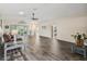 Spacious living room featuring wood-look floors and a ceiling fan at 533 Grand Vista Trl, Leesburg, FL 34748