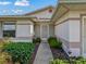Inviting front entry with landscaping and a screened door at 533 Grand Vista Trl, Leesburg, FL 34748