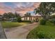 Inviting home exterior at dusk, showcasing curb appeal at 512 Palo Verde Dr, Leesburg, FL 34748