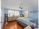 Main bedroom with light blue walls and wood flooring at 512 Palo Verde Dr, Leesburg, FL 34748