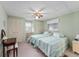 Bedroom with twin beds and ceiling fan at 512 Palo Verde Dr, Leesburg, FL 34748