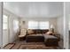 Cozy living room featuring a brown sectional sofa and a wicker chair at 512 Palo Verde Dr, Leesburg, FL 34748