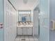 Bathroom with vanity, mirror and access to closets at 512 Palo Verde Dr, Leesburg, FL 34748