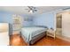 Light blue bedroom with double bed, nightstand and access to bathroom at 512 Palo Verde Dr, Leesburg, FL 34748
