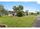 Single-story home with a well-manicured lawn at 512 Palo Verde Dr, Leesburg, FL 34748