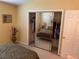 Bedroom with mirrored closet doors and neutral wall color at 1150 Paradise Dr, The Villages, FL 32159