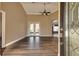 Bright living room with hardwood floors and french doors at 27303 Gingerbread Pl, Leesburg, FL 34748