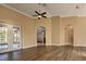 Spacious living room with hardwood floors and access to backyard at 27303 Gingerbread Pl, Leesburg, FL 34748