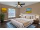 Bedroom with hardwood floors, ceiling fan, and neutral wall colors at 27303 Gingerbread Pl, Leesburg, FL 34748