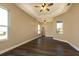 Bright and airy living room with wood-look floors and ceiling fans at 27303 Gingerbread Pl, Leesburg, FL 34748
