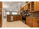 Kitchen with stainless steel appliances, granite countertops, and ample wood cabinetry at 27303 Gingerbread Pl, Leesburg, FL 34748