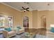Living area with hardwood floors and comfy seating at 27303 Gingerbread Pl, Leesburg, FL 34748