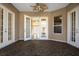 Sunroom with French doors, ceiling fan, and pebble flooring at 27303 Gingerbread Pl, Leesburg, FL 34748