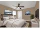 Spacious main bedroom with a bed, wood-look floors, and artwork at 27303 Gingerbread Pl, Leesburg, FL 34748