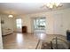 Living room with tile flooring, sliding doors to a screened porch, and comfortable seating at 3680 Doune Way, Clermont, FL 34711