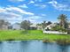 House on lake with large backyard and white fence at 875 Delfino Pl, Lake Mary, FL 32746