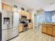 Kitchen boasts stainless steel appliances and wood cabinets at 36839 Wolf Ct, Eustis, FL 32726