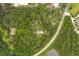 House nestled in a wooded lot with a nearby road at 1136 Brick Rd, Winter Garden, FL 34787