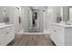 Luxurious bathroom with double vanities, large mirror, and walk-in shower at 1136 Brick Rd, Winter Garden, FL 34787