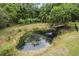 Picturesque pond with lush vegetation and a wooden platform at 1136 Brick Rd, Winter Garden, FL 34787