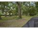 Lush green lawn and mature trees create a tranquil atmosphere at 1136 Brick Rd, Winter Garden, FL 34787
