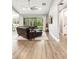 Spacious living room with L-shaped sectional sofa and hardwood floors at 1136 Brick Rd, Winter Garden, FL 34787