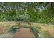 Wooden dock extending over a tranquil pond at 1136 Brick Rd, Winter Garden, FL 34787