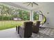 Relaxing back patio with wicker chairs and view of the fenced backyard at 1136 Brick Rd, Winter Garden, FL 34787