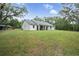 White house exterior with green lawn and large backyard at 1136 Brick Rd, Winter Garden, FL 34787