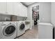 Laundry room with washer, dryer, cabinets, and utility sink at 1136 Brick Rd, Winter Garden, FL 34787