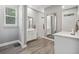 Modern bathroom with double vanity, walk-in shower, and gray tile at 1136 Brick Rd, Winter Garden, FL 34787