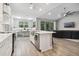 Open concept kitchen with island, stainless steel appliances, and white cabinetry at 1136 Brick Rd, Winter Garden, FL 34787