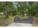 Curved driveway leading through a tree-lined landscape at 1136 Brick Rd, Winter Garden, FL 34787