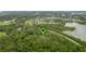 Aerial view showing home nestled in a wooded area near a lake at 1136 Brick Rd, Winter Garden, FL 34787