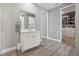 Bathroom with single vanity, walk-in shower, and access to closet at 1136 Brick Rd, Winter Garden, FL 34787
