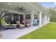 Covered patio with ceiling fan, comfortable seating, and grassy yard at 1136 Brick Rd, Winter Garden, FL 34787