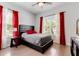 Bedroom with a bed, red curtains, and hardwood floors at 9424 Royal Estates Blvd, Orlando, FL 32836