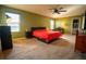 Main bedroom with green walls and ceiling fan at 11430 Wishing Well Ln, Clermont, FL 34711
