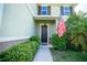 Inviting front entrance with dark brown door and lush landscaping at 11430 Wishing Well Ln, Clermont, FL 34711