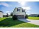 Two story house with a two car garage and landscaped lawn at 11430 Wishing Well Ln, Clermont, FL 34711