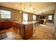 Open kitchen features an island and views into the living room at 11430 Wishing Well Ln, Clermont, FL 34711
