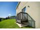 Elevated wooden deck with railing overlooks a grassy backyard at 11430 Wishing Well Ln, Clermont, FL 34711