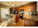 Modern kitchen with wood cabinets, granite counters, and island at 11430 Wishing Well Ln, Clermont, FL 34711